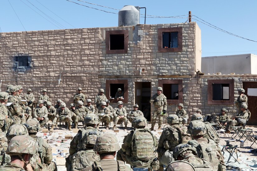 Brig. Gen. Michael Wegscheider, standing, the 28th Infantry Division's deputy commanding general-maneuver, makes closing remarks during the 56th Stryker Brigade Combat Team's final combined arms rehearsal at the National Training Center, Fort Irwin, Calif., July 7, 2022. Wegscheider led a senior trainer team of two dozen planners, logisticians and other specialists who observed the brigade's NTC rotation.