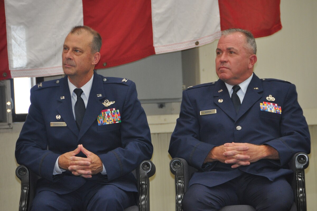 two men listen to another speak