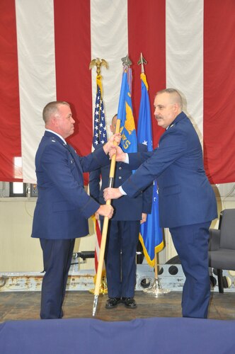 a man hands another man a flag