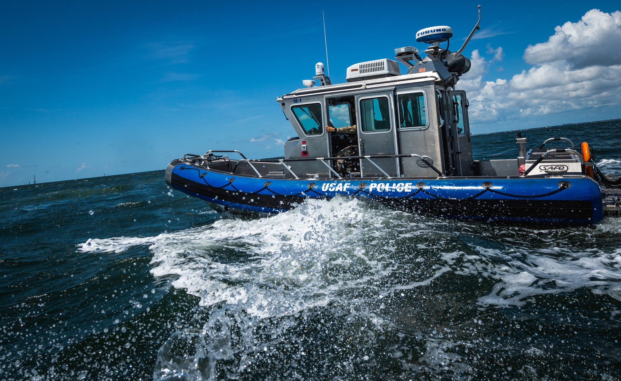 U.S. marine patrolmen assigned to the 6th Security Forces Squadron operate a vessel during a routine patrol in Tampa Bay, Florida, July 10, 2022. On June 12, marine patrolmen Airman 1st Class Samari Rivera-Rodriguez, Kade Jones, and Sabin Venable, along with Staff Sgt. Au rescued eight victims who were stranded on top of a capsized vessel in Tampa Bay while on patrol. The 6th SFS Marine Patrol unit is the only fully operational, 24/7 unit in the Air Force, and is responsible for protecting one of the largest coastal restricted areas in the Department of Defense. (U.S. Air Force photo by Staff Sgt. Alexander Cook)