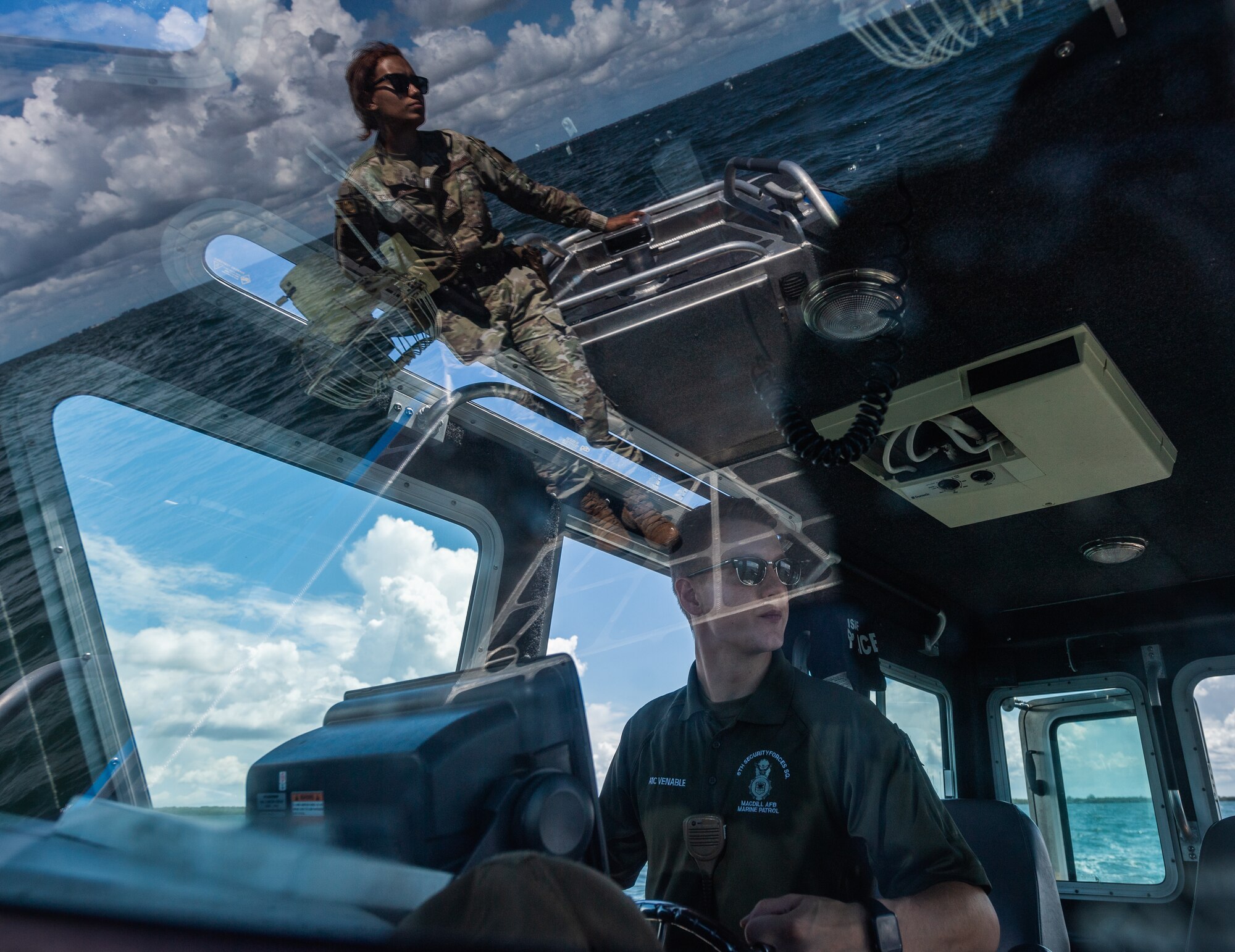 U.S. Air Force Airmen 1st Class Samari Rivera-Rogriguez, left, and Sabin Venable conduct a routine patrol along the coastline of MacDill Air Force Base, Florida, July 10, 2022. On June 12, marine patrolmen Airman 1st Class Samari Rivera-Rodriguez, Kade Jones, and Sabin Venable, along with Staff Sgt. William Au rescued eight victims who were stranded on top of a capsized vessel in Tampa Bay while on patrol. The 6th SFS Marine Patrol unit is the only fully operational, 24/7 unit in the Air Force, and is responsible for protecting one of the largest coastal restricted areas in the Department of Defense. (U.S. Air Force photo by Staff Sgt. Alexander Cook)