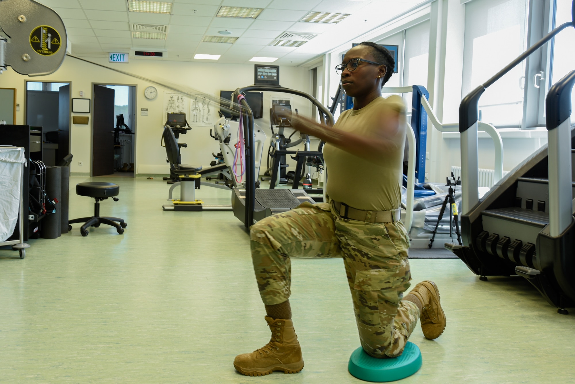 U.S. Air Force Staff Sgt. Lashawn Dennis, 52nd Fighter Wing non-commissioned officer in charge of the wing professional development office, performs a physical therapy exercise in the medical clinic at Spangdahlem Air Base, Germany, June 14, 2022. Physical therapy allows Airmen to work through their injuries and provides tools for prevention in the future. (U.S. Air Force photo by Staff Sgt. Chance Nardone)