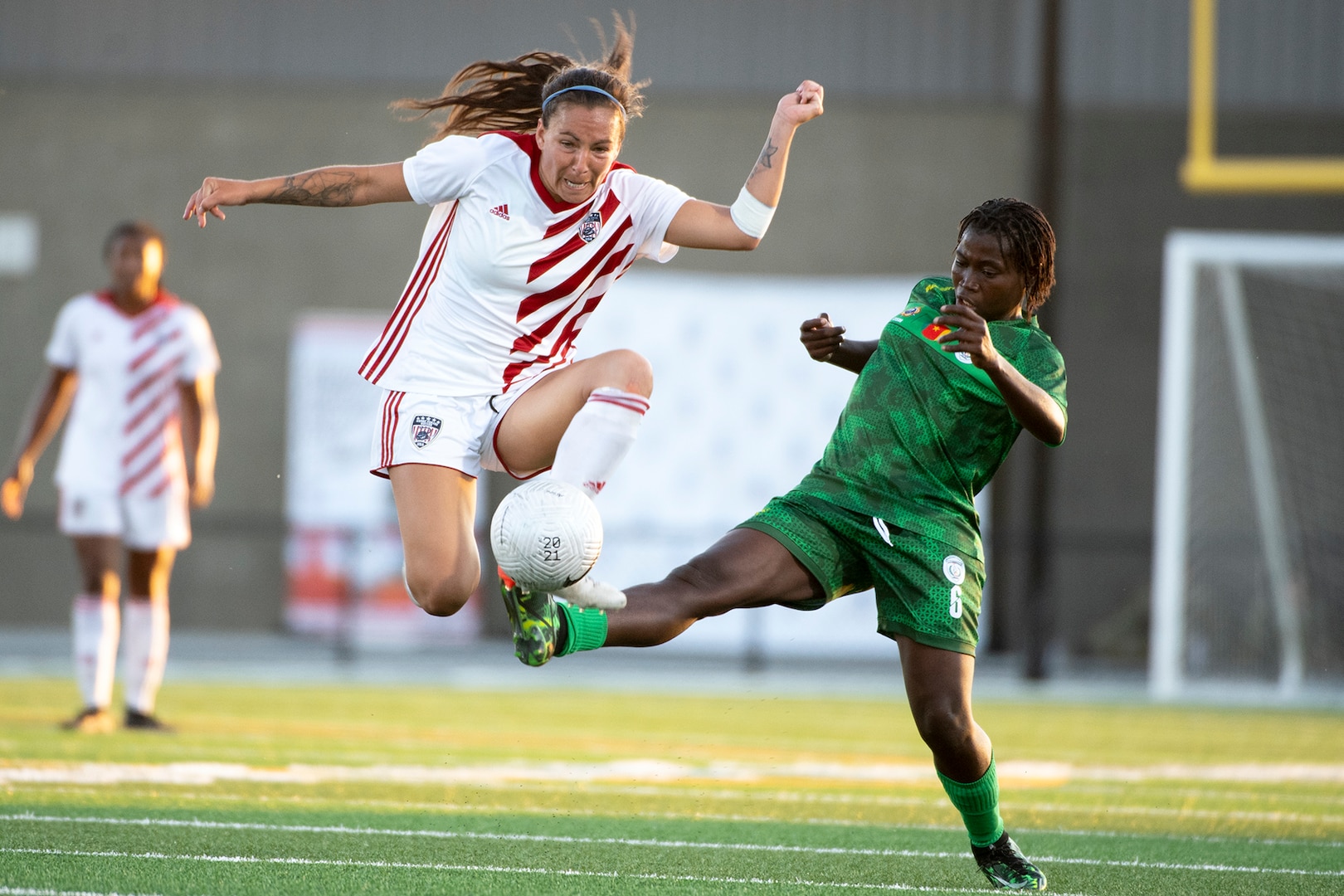 Air Force Capt. Angela Karamanos of the U.S. Armed Forces Women’s Soccer Team makes a leaping kick over the leg of Cameroon’s Si’Ndje Tchanko during a match of the 13th CISM (International Military Sports Council) World Military Women’s Football Championship in Meade, Washington July 13, 2022. (DoD photo by EJ Hersom)