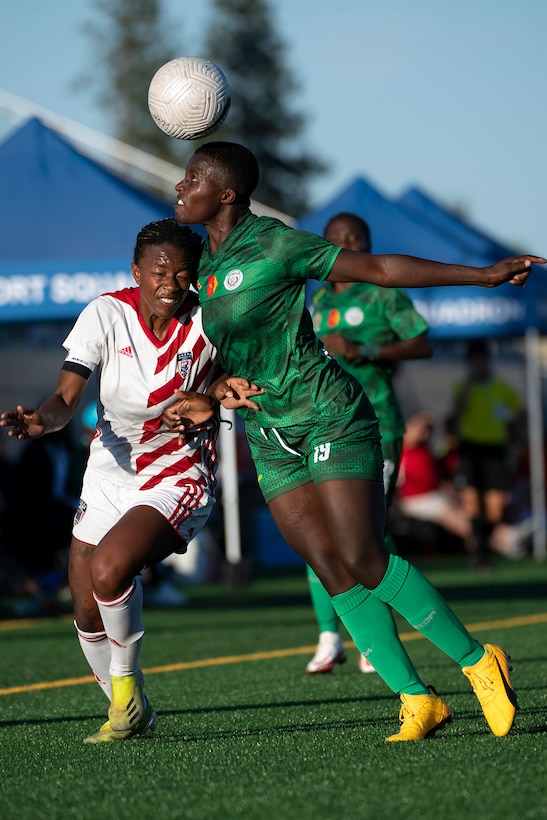 Cameroon’s Sandrine Kernyuy Lavngeh heads a ball over Army 1st Lt. Haley Roberson of the U.S. Armed Forces Women’s Soccer Team during the 13th CISM (International Military Sports Council) World Military Women’s Football Championship in Meade, Washington July 13, 2022. (DoD photo by EJ Hersom)
