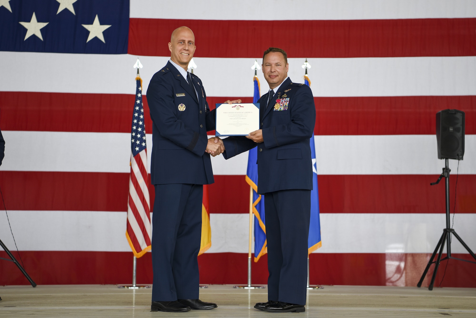 U.S. Air Force Brig. Gen. Josh Olson, 86th Airlift Wing commander, left, presents Col. Anthony M. Nance, 86th Maintenance Group outgoing commander, with a Legion of Merit certificate during the 86 CEG change of command ceremony at Ramstein Air Base, Germany, July 13, 2022.