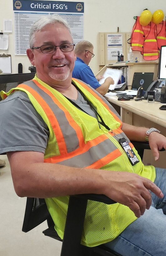 Man sitting in chair smiling.