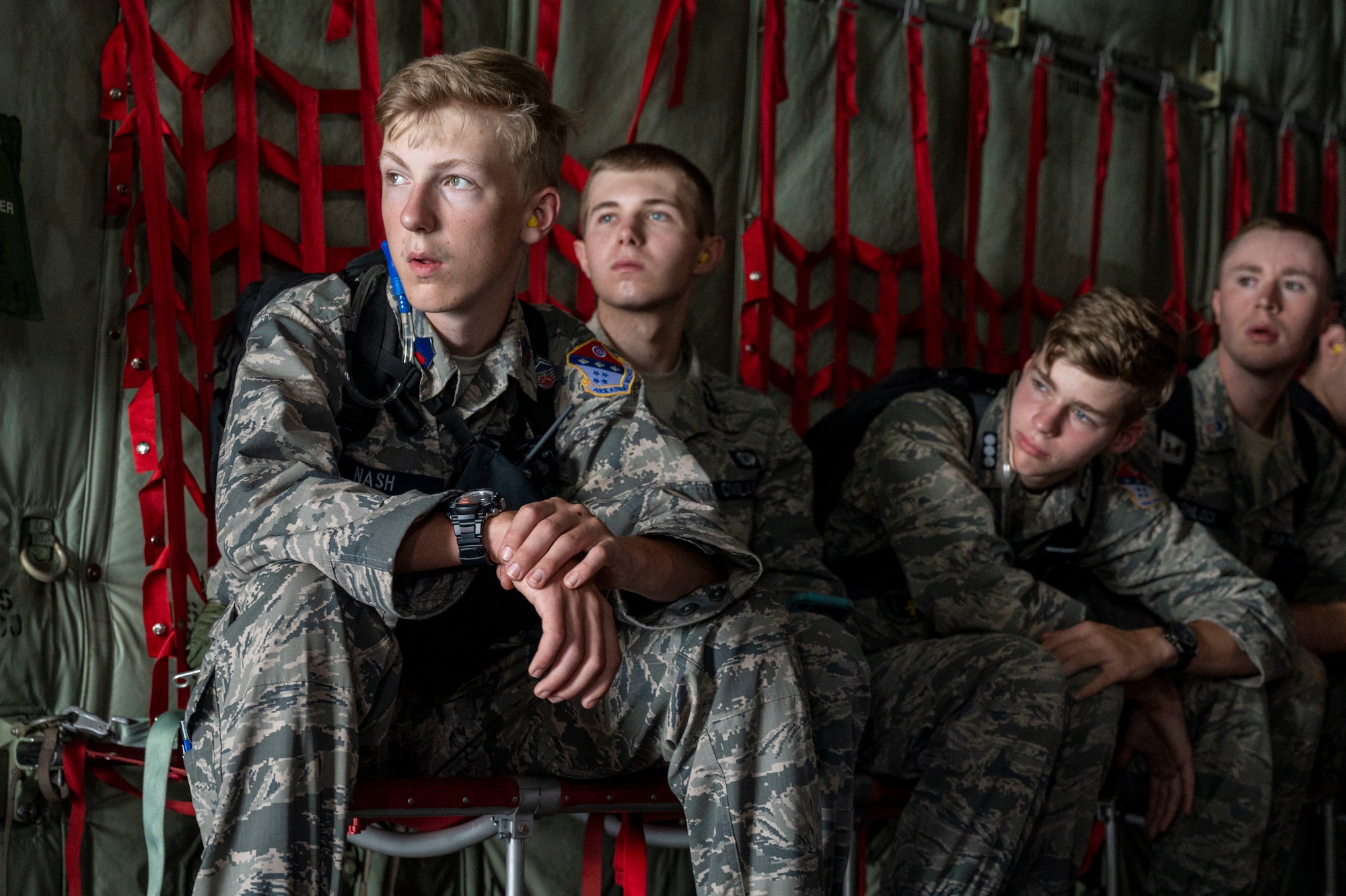 Civil Air Patrol cadets look out the rear cargo door of a C-130J Super Hercules during an orientation flight