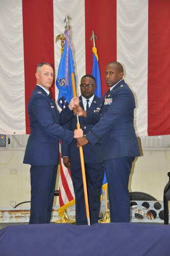 a man hands another man a flag