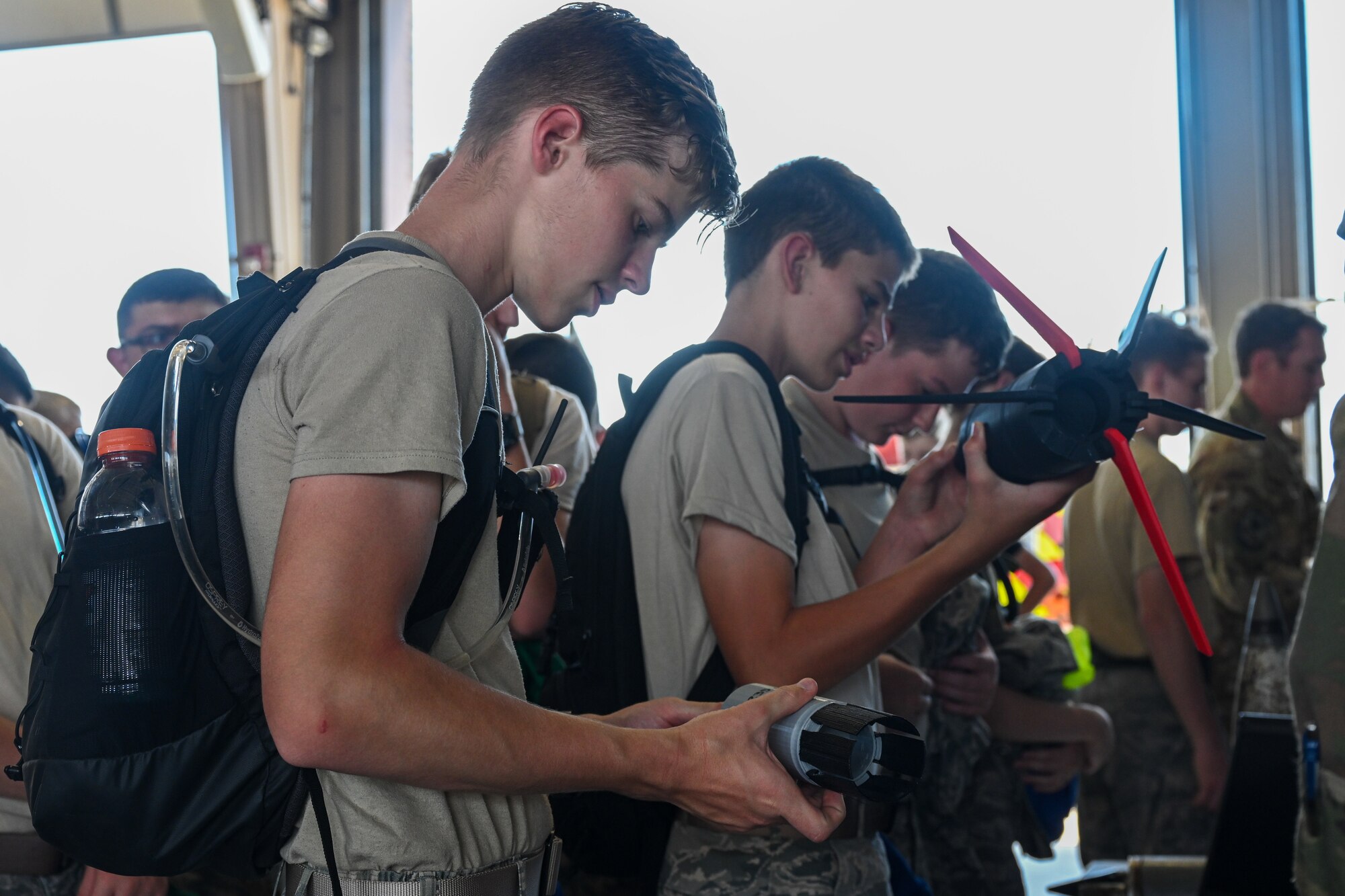 Civil Air Patrol cadets examine various explosive ordnance disposal training devices during a base visit
