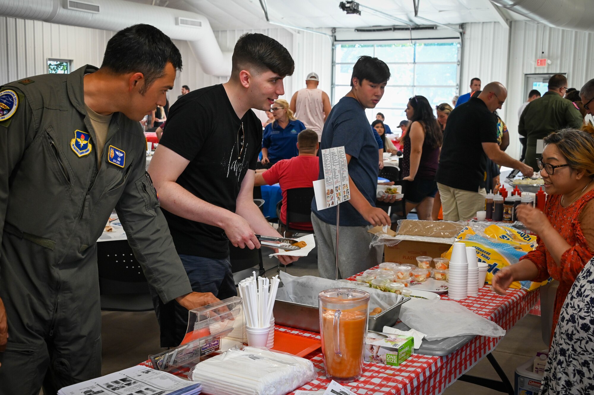 Airmen from Altus Air Force Base (AAFB), Oklahoma, talk with community members at the “Taste of Altus” event, July 11, 2022. Among the 100 attendees were community members, AAFB Airmen and families. (U.S. Air Force photo by Senior Airman Kayla Christenson)