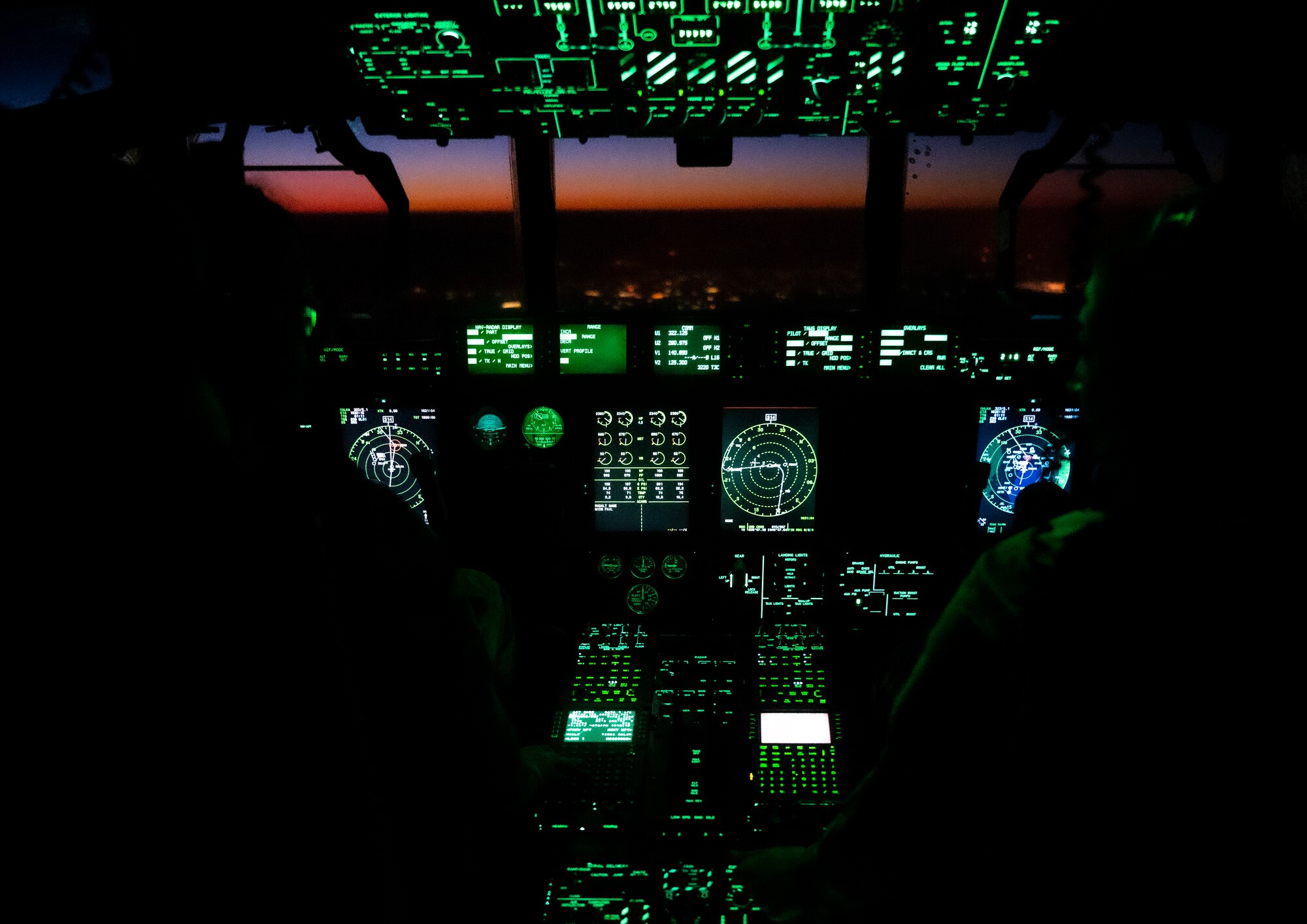 U.S. Air Force Capt. Morgan Eckert, left, and Capt. Julia Sunnekalb, right, 41st Expeditionary Airlift Squadron C-130J Super Hercules pilots, fly over the U.S. Central Command area of responsibility