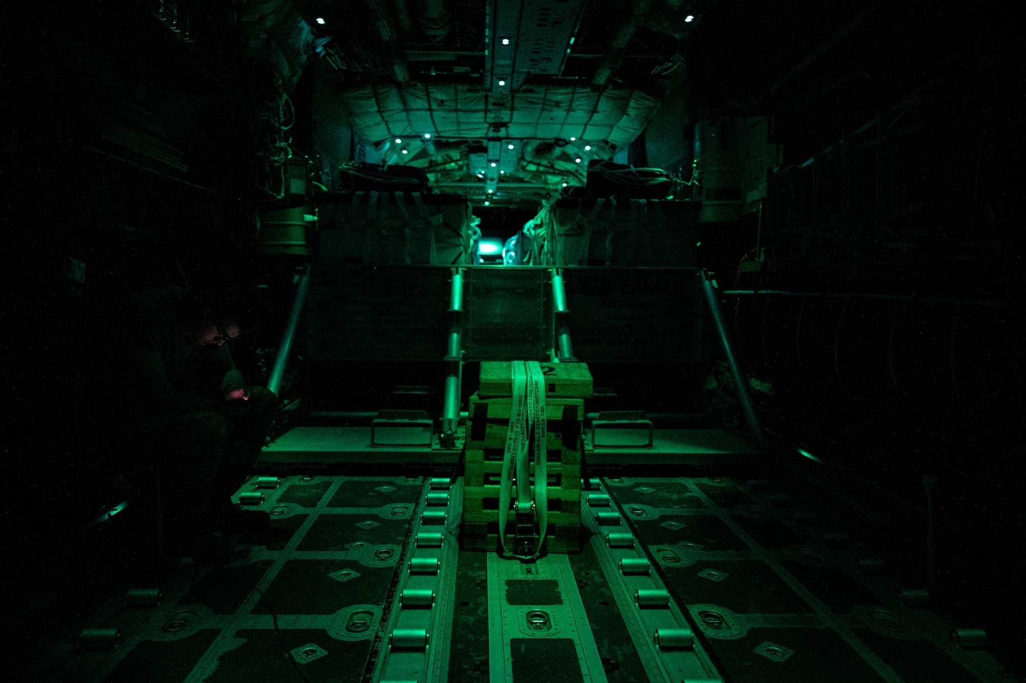 U.S. Air Force Airman Hunter Zagorski, a 41st Expeditionary Airlift Squadron loadmaster, awaits a combat drop over the U.S. Central Command area of responsibility