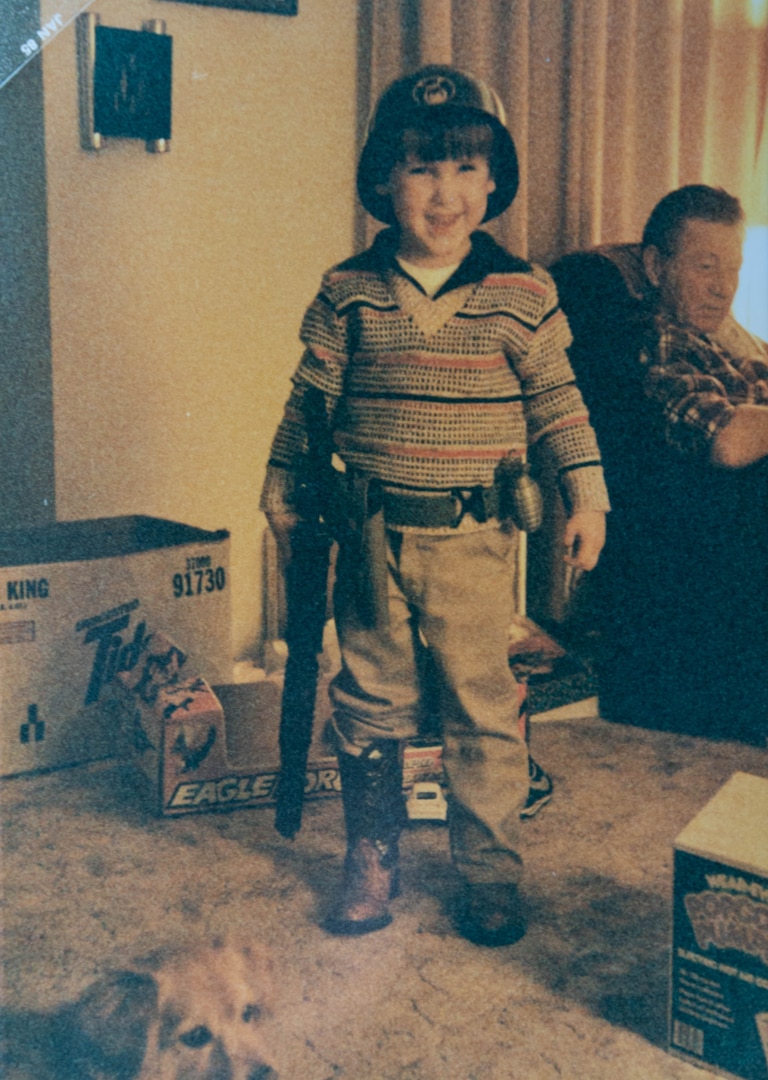 male child playing dress up in military gear