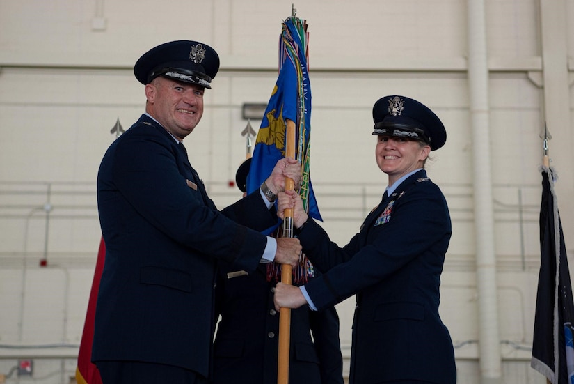 Three military members stand at attention