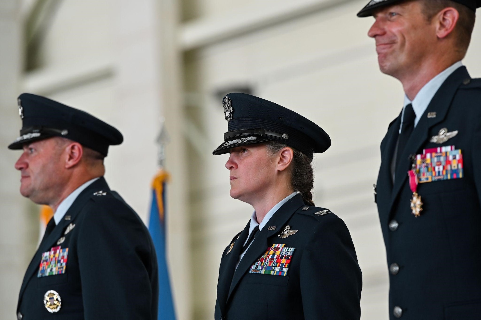Three military members stand at attention