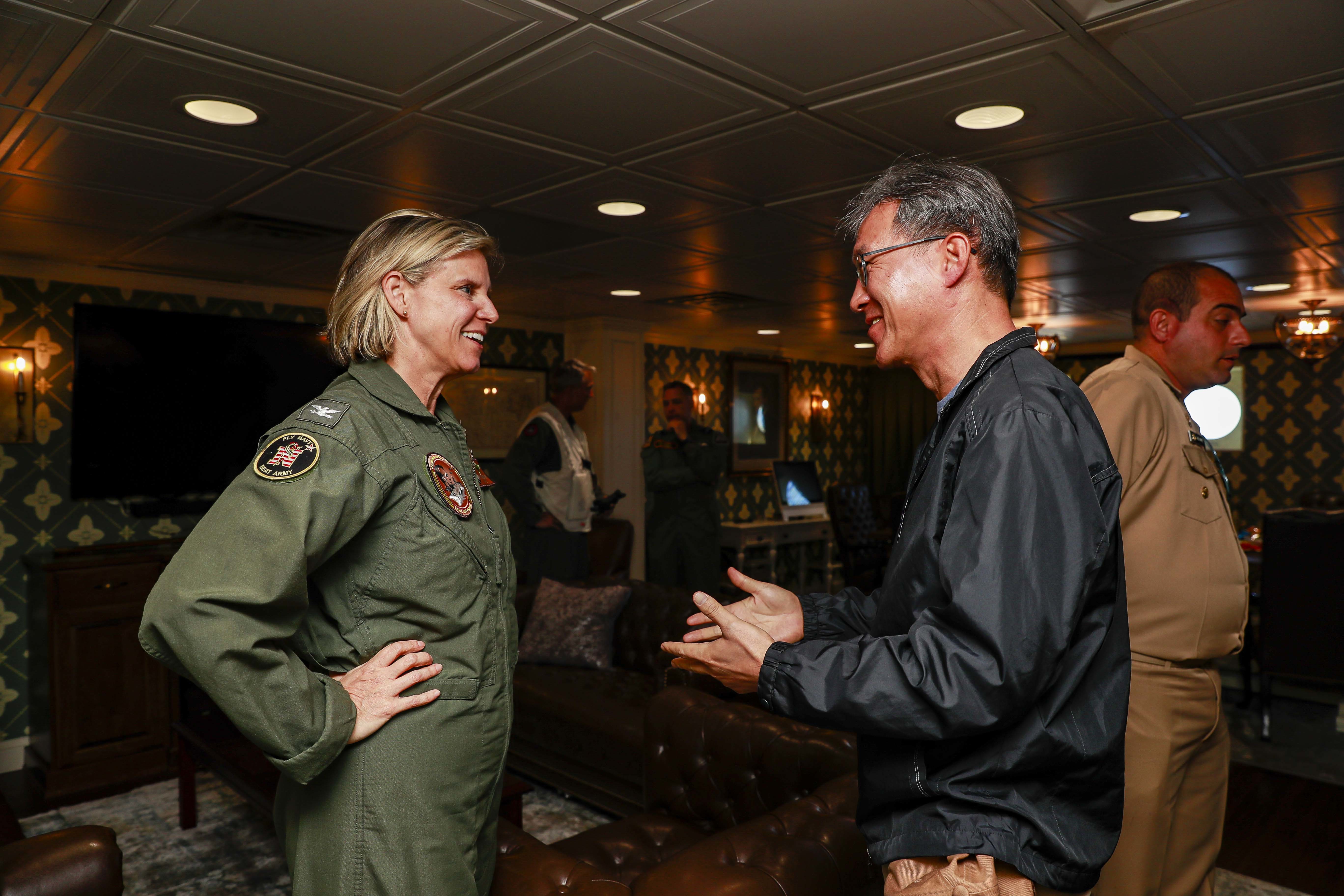 Capt. Amy Bauernschmidt, commanding officer of the Nimitz-class aircraft carrier USS Abraham Lincoln (CVN 72), welcomes leaders from the Republic of Korea, Peruvian navy, and Royal Air Force aboard Abraham Lincoln during Rim of the Pacific (RIMPAC) 2022.
