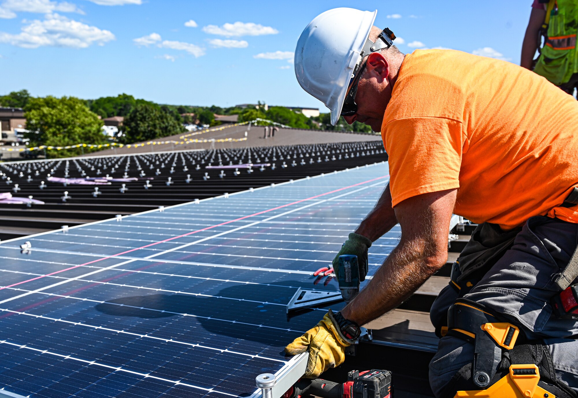 More than 7,100 photovoltaic solar panels are being laid down on rooftops across the joint base in an project to reduce the demand off the commercial electric grid and make the base's utilities more resilient.