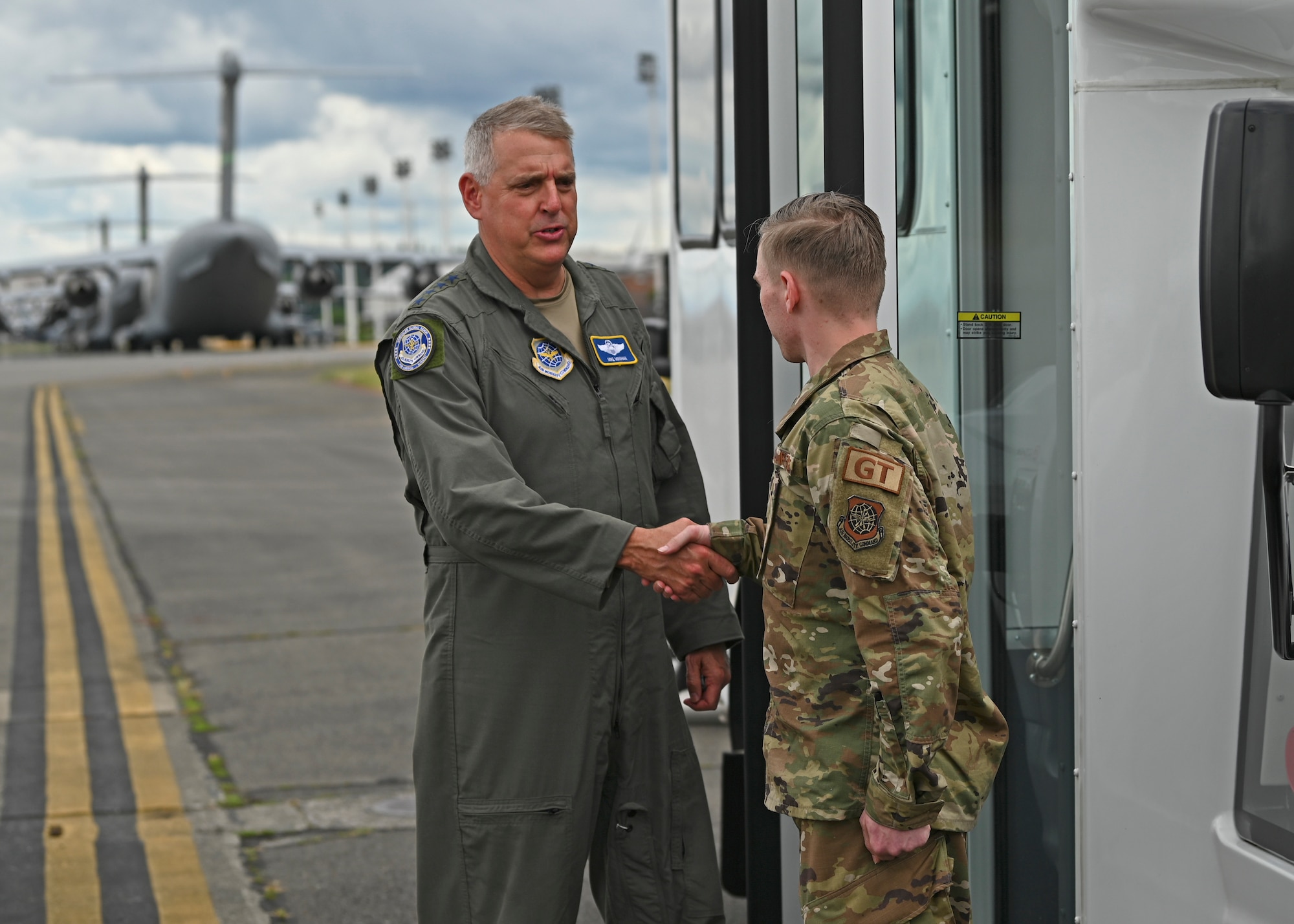 U.S. Air Force Gen. Mike Minihan, Air Mobility Command commander, left, coins Airman 1st Class Julian Culpepper, a ground transportation operator with the 627th Logistics Readiness Squadron, during his visit to Joint Base Lewis-McChord, Washington, July 7, 2022. Minihan and Chief Master Sgt. Brian Kruzelnick, AMC command chief, spent two days visiting Team McChord and recognized several of the wing’s outstanding performers during their time. (U.S. Air Force photo by Senior Airman Callie Norton)