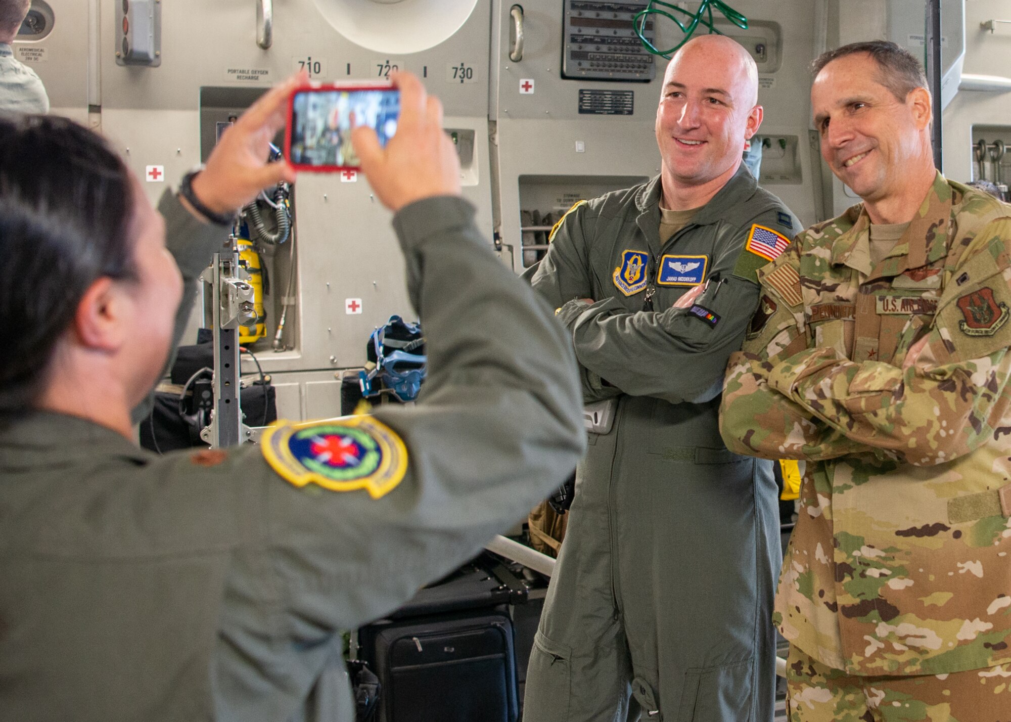 Maj. Gen. Jeffrey T. Pennington, 4th Air Force commander, takes a selfie with Capt. Jarad Reddekopp, 349th Aeromedical Evacuation Squadron flight nurse, during his visit July 9, 2022, at Travis Air Force Base, Calif.  The opportunity allowed the 349th Air Mobility Wing to showcase its people, mission, accomplishments, and innovation efforts.