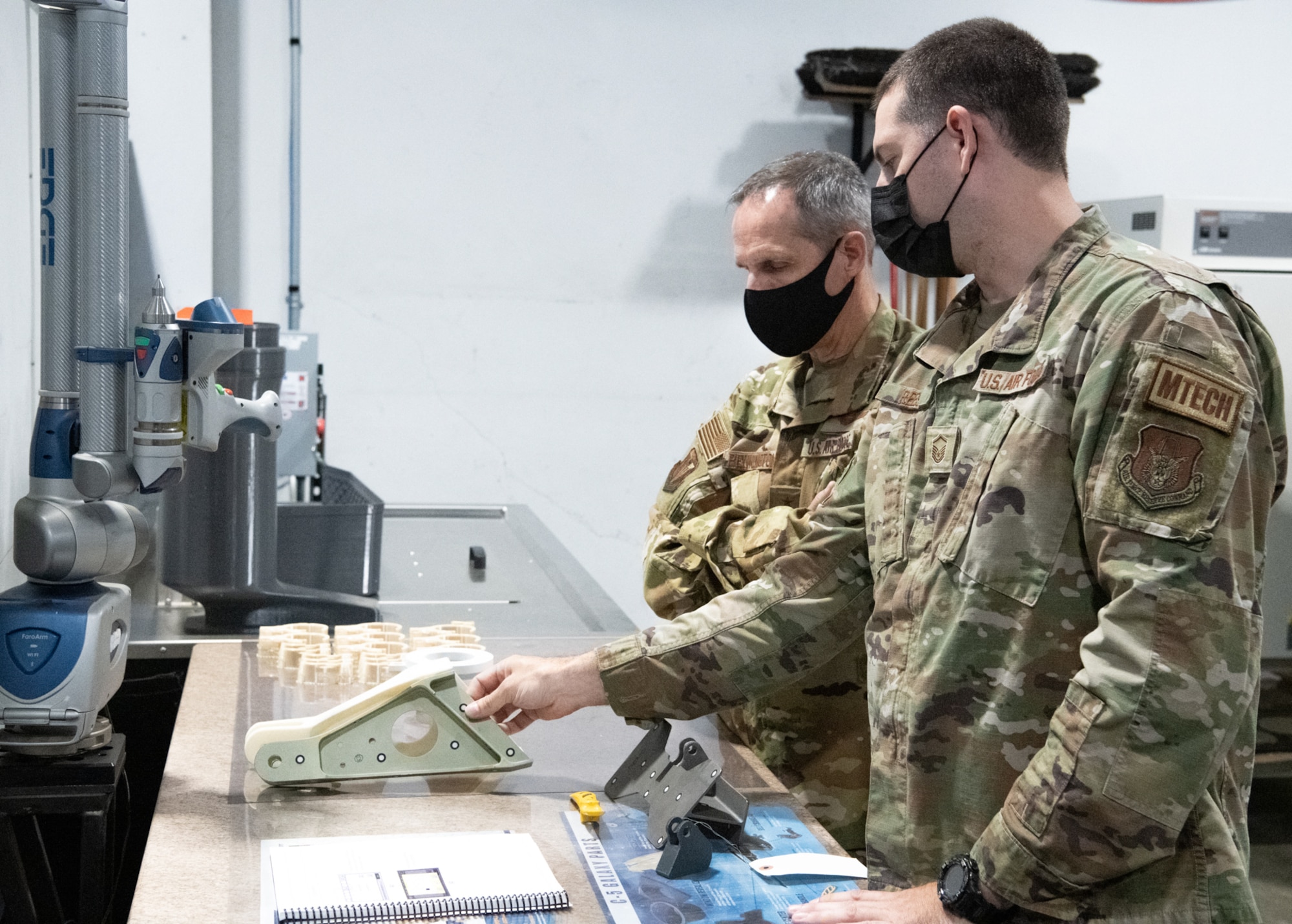 Master Sgt. Reed, 349th Maintenance Squadron, demonstrates the benefits of 3D printing at Travis Air Force Base, Calif. to Maj. Gen. Jeffrey T. Pennington, 4th Air Force commander, on July 10, 2022. The opportunity was one of many that allowed the 349th Air Mobility Wing to showcase its people, mission, accomplishments and innovative efforts