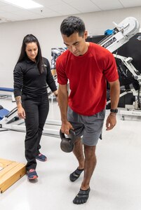 U.S. Air Force Staff Sgt. Emily Valdovinos (left), Special Warfare Human Performance Squadron physical medicine technician, works with Col Raja Chari, NASA astronaut, on a strengthening exercise for Chari’s post-flight reconditioning at the Johnson Space Center in Houston, Texas, Jun. 16, 2022. Valdovinos was hand-selected by the NASA Astronaut Strength, Conditioning and Rehab Group to help develop personalized strength, conditioning, and rehabilitative plans for NASA astronauts.