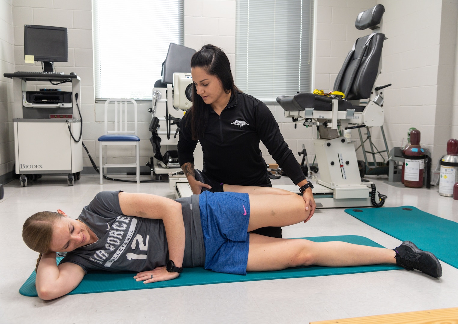 U.S. Air Force Staff Sgt. Emily Valdovinos (far center), Special Warfare Human Performance Squadron physical medicine technician, works with Maj. Nichole Ayers (near center), NASA astronaut candidate, on routine mobility exercises at the Johnson Space Center in Houston, Texas, Jun. 16, 2022. Valdovinos was hand-selected by the NASA Astronaut Strength, Conditioning and Rehab Group to help develop personalized strength, conditioning, and rehabilitative plans for NASA astronauts.