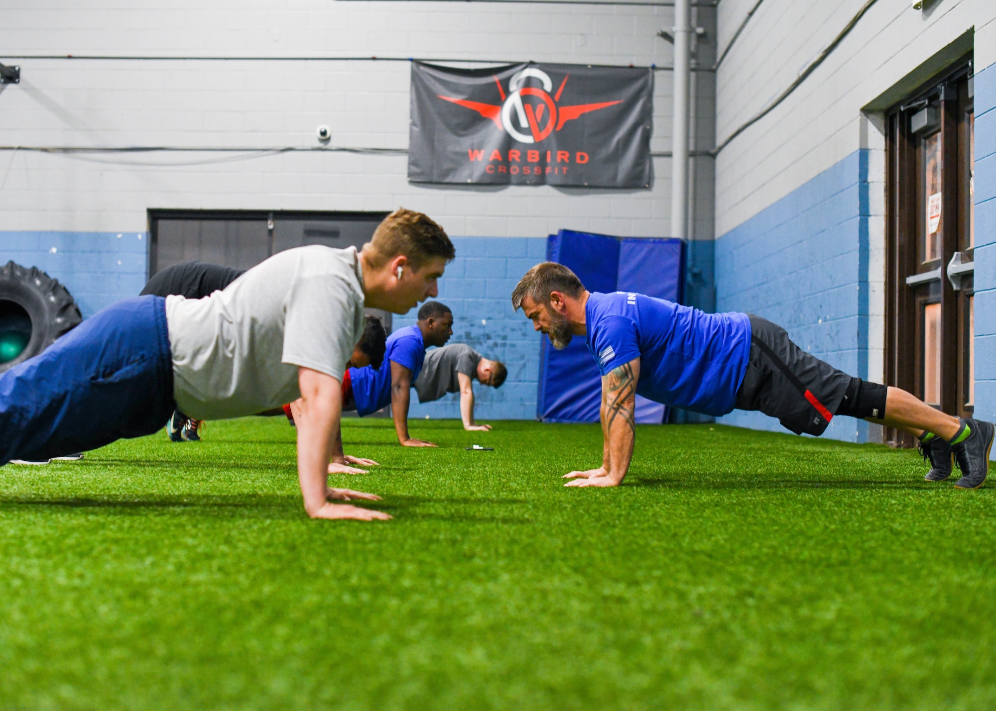Brett Carbo, 75th Force Support Squadron training specialist, teaches proper push-up technique at the Hess Fitness Center on Hill Air Force Base.