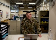 Senior Airman James Gilchrest, 168th Communications Flight Client Systems specialist, Alaska Air National Guard, and Air Force Gaming program manager, checks a computer dropped off to the 168th Communications Flight, Alaska Air National Guard, Oct. 25, 2021, at Eielson Air Force Base, Alaska. Gilchrest is active with Air Force Gaming as a user and program manager in his off-duty time, which was started to help promote resiliency, retention, teamwork, and a community for Airmen in their off time. (U.S. Air National Guard photo by Tech. Sgt. Adam Keele)