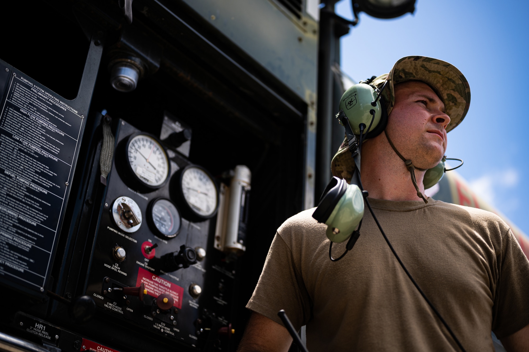 Airman looks at plane refueling.