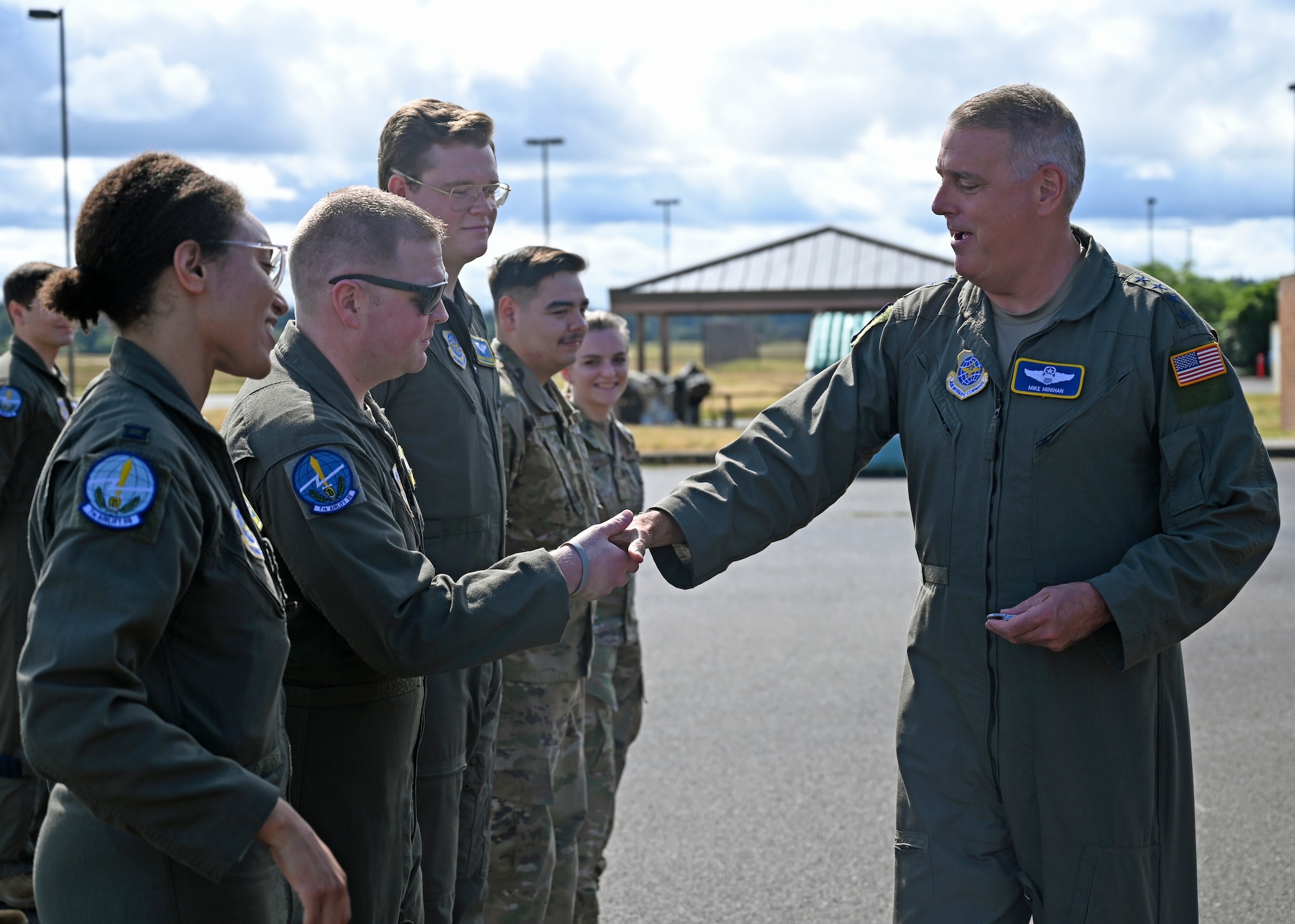 U.S. Air Force Gen. Mike Minihan, Air Mobility Command commander, coins the 2021 AMC Doolittle Award winners during his visit to Joint Base Lewis-McChord, Washington, July 7, 2022. The crew of RCH683 was recognized for their participation in Operation ALLIES REFUGE, which enabled thousands of Afghani’s evacuation from Kabul, Afghanistan, in August 2021. (U.S. Air Force photo by Senior Airman Callie Norton)