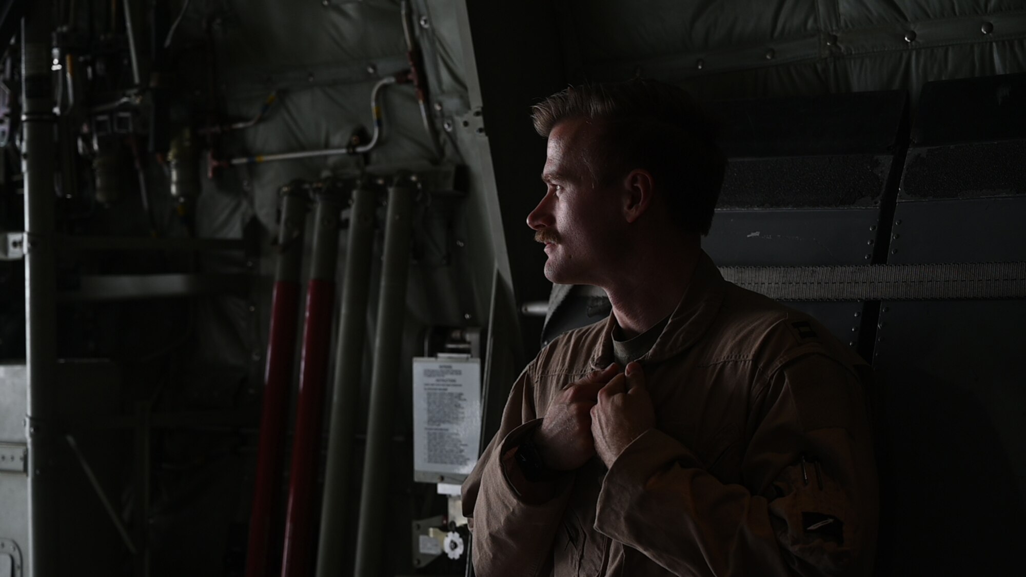 U.S. Air Force Capt. Jeremy Sarno, a 41st Expeditionary Airlift Squadron C-130J Super Hercules pilot, watches while the aircraft is loaded with cargo