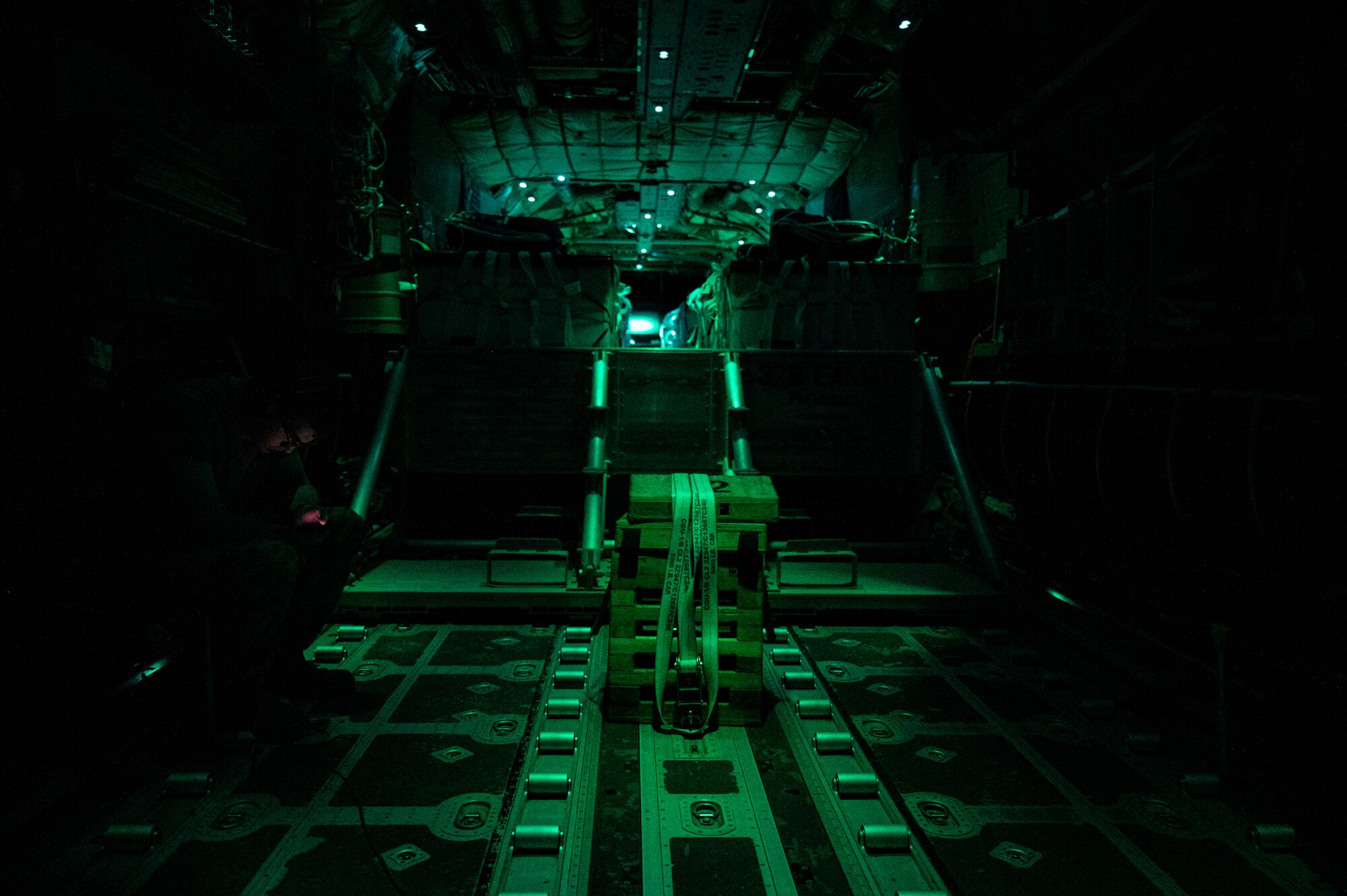 U.S. Air Force Airman Hunter Zagorski, a 41st Expeditionary Airlift Squadron loadmaster, awaits a combat drop over the U.S. Central Command area of responsibility