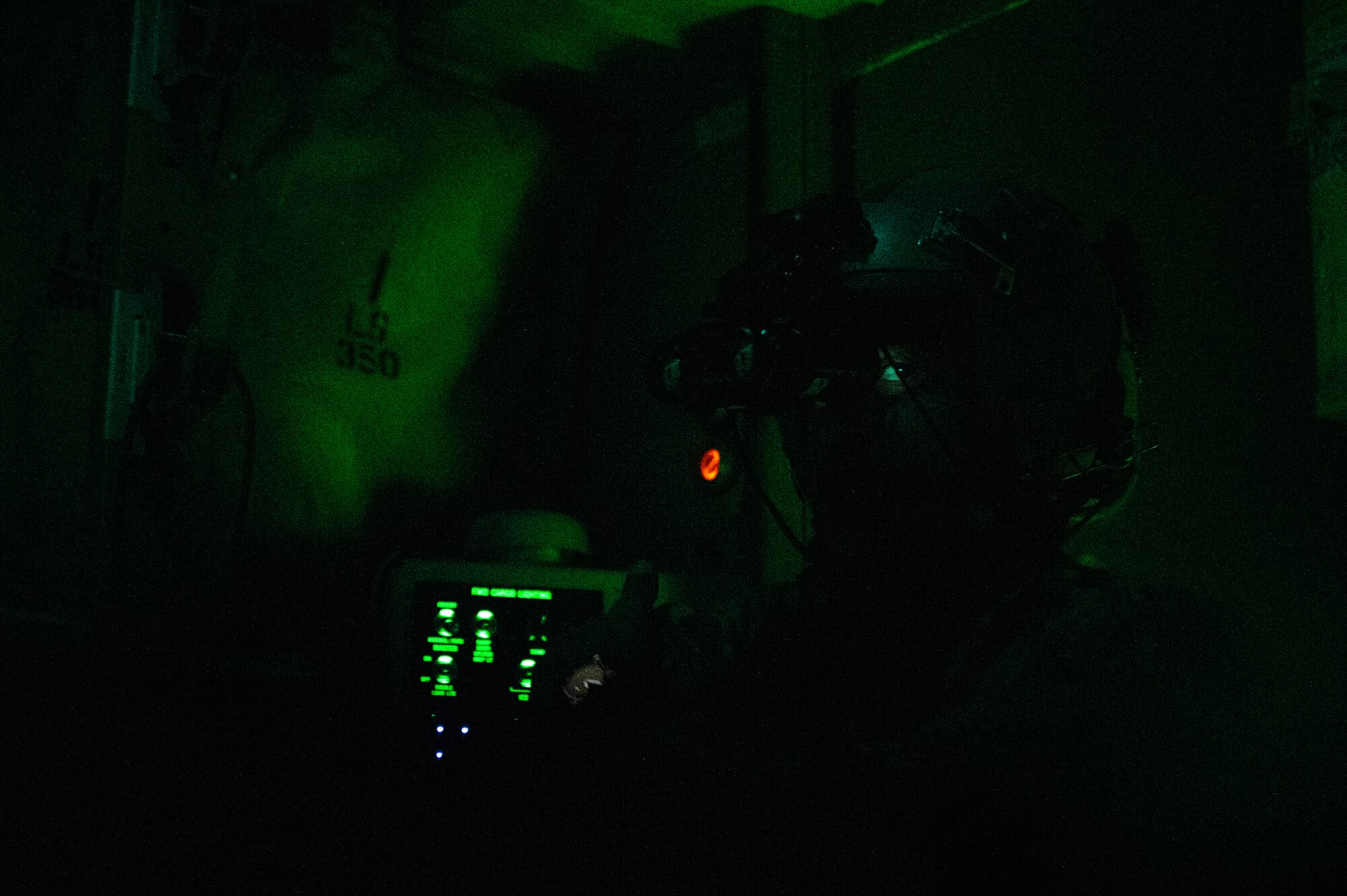 U.S. Air Force Tech. Sgt. Anthony Miller, a 41st Expeditionary Airlift Squadron loadmaster, prepares for a cargo drop over the U.S. Central Command area of responsibility,