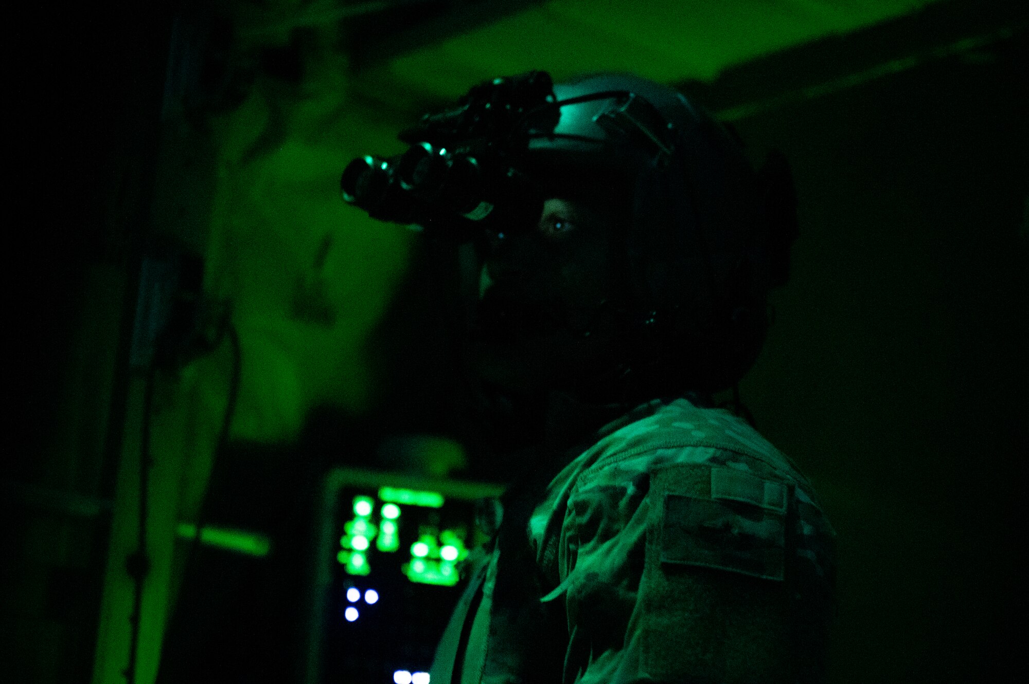 U.S. Air Force Tech. Sgt. Anthony Miller, a 41st Expeditionary Airlift Squadron loadmaster, prepares for a cargo drop over the U.S. Central Command area of responsibility