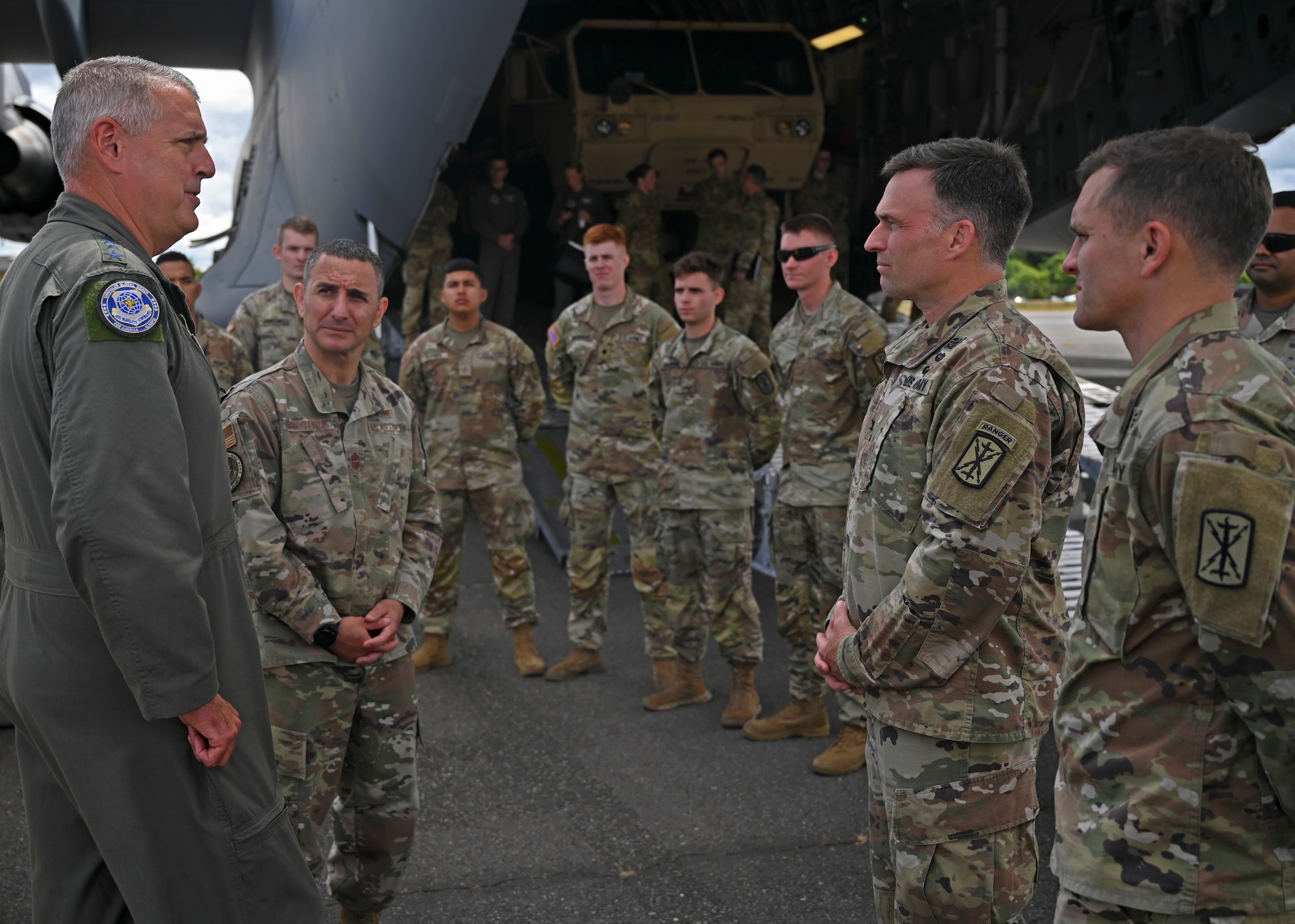 U.S. Air Force Gen. Mike Minihan, left, Air Mobility Command commander, and Chief Master Sgt. Brian Kruzelnick, AMC command chief, speak with U.S. Soldiers from the 17th Field Artillery Brigade at Joint Base Lewis-McChord, Washington, July 7, 2022. Minihan and Kruzelnick spent two days experiencing the mission, priorities and joint operations of America’s Airlift Wing. (U.S. Air Force photo by Senior Airman Callie Norton)