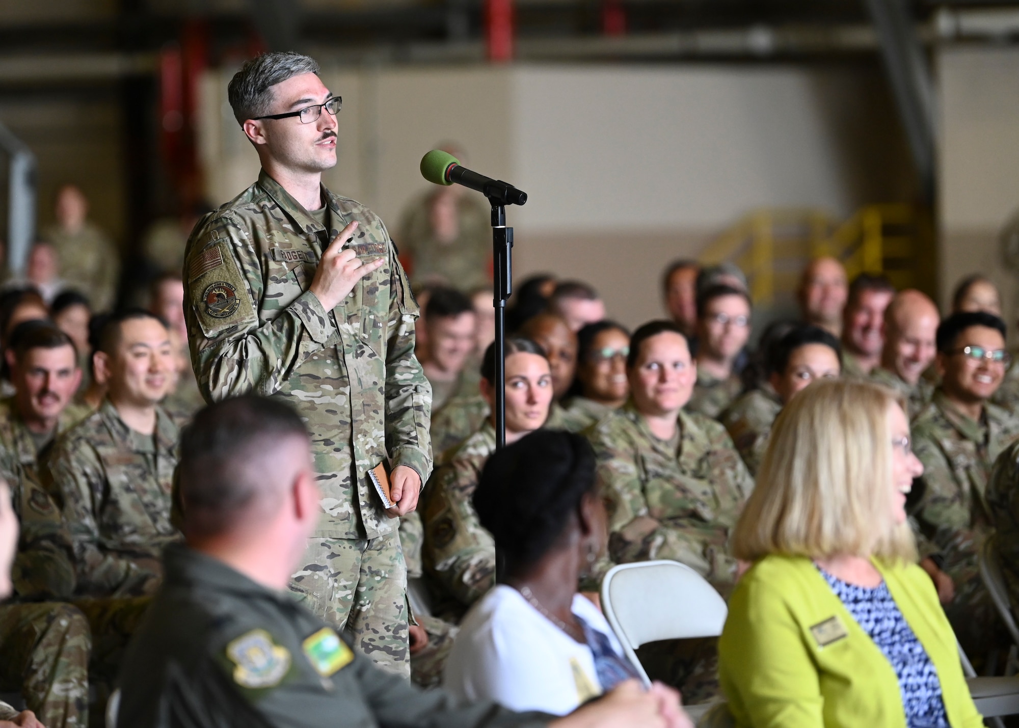 U.S. Air Force Senior Airman Austin Padgett, a response force member with the 627th Security Forces Squadron, asks Gen. Mike Minihan, Air Mobility Command commander, a question during an all-call at Joint Base Lewis-McChord, Washington, July 7, 2022. Minihan and Chief Master Sgt. Brian Kruzelnick, AMC command chief, spent two days visiting Team McChord to experience the way America’s Airlift Wing executes rapid global mobility. (U.S. Air Force photo by Senior Airman Callie Norton)