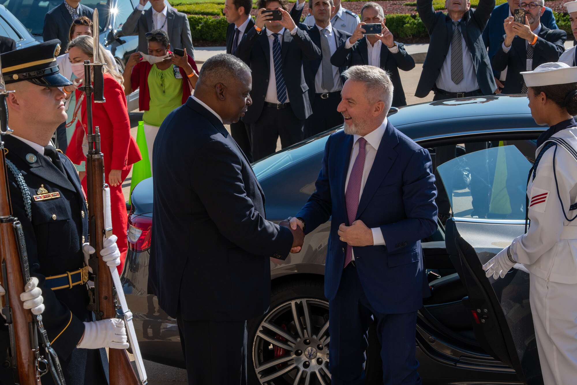 Two men shake hands.