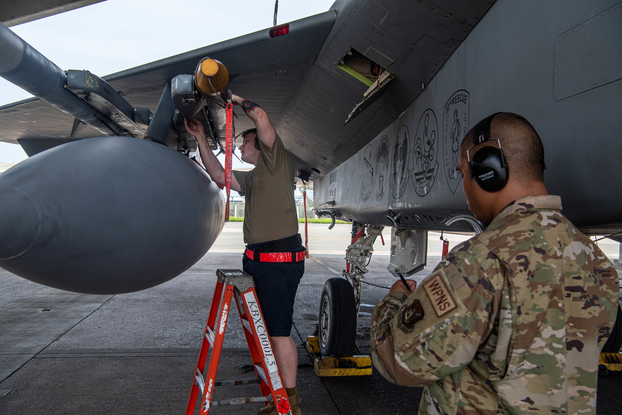 An Airman inspects a missile to ensure it was loaded correctly during the F-15 Load Crew of the Quarter Competition at Kadena Air Base, Japan, July 15, 2022.