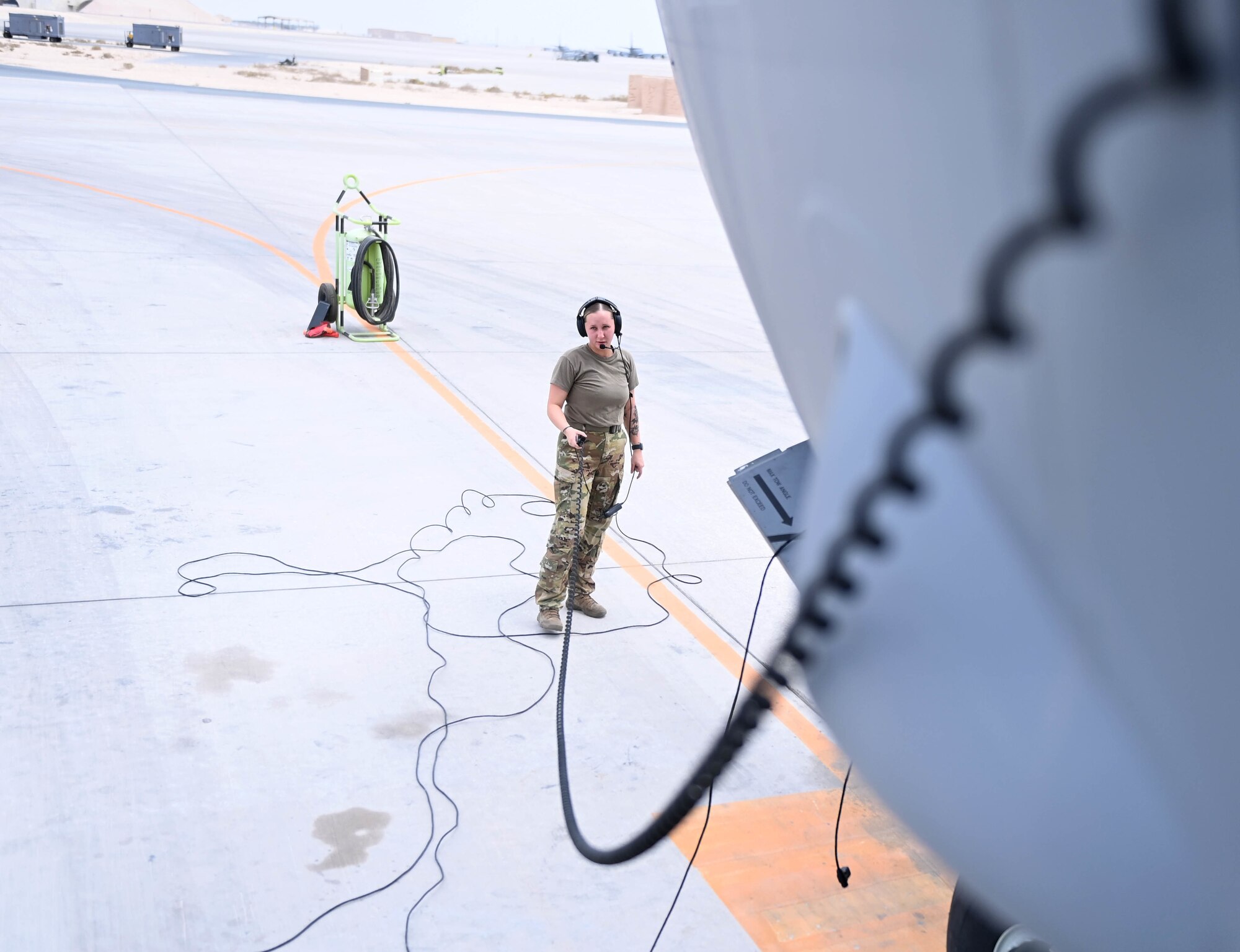 U.S. Air Force Airman 1st Class Mikaela Branchfield, an 816th Expeditionary Airlift Squadron loadmaster, conducts a preflight test by a C-17 Globemaster, July 12, 2022 at Al Udeid Air Base, Qatar. C-17 aircraft provide the strategic capability of transporting mission materials and personnel. (U.S. Air National Guard photo by Tech. Sgt. Michael J. Kelly)