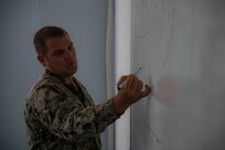 Senior Chief Explosive Ordnance Disposal Matthew Kuttenkuler, assigned to Explosive Ordnance Disposal Mobile Unit (EODMU) 12, delivers a brief on U.S. floating mine response procedures to Bulgarian Sailors as part of a knowledge exchange between the two nations during exercise Breeze 2022, July 14, 2022. Breeze 2022 enhances interoperability among Bulgaria and participating nations, with an emphasis on anti-submarine warfare, search and rescue, force protection/anti-terrorism operations, maritime interdiction operations, and anti-piracy mission areas.