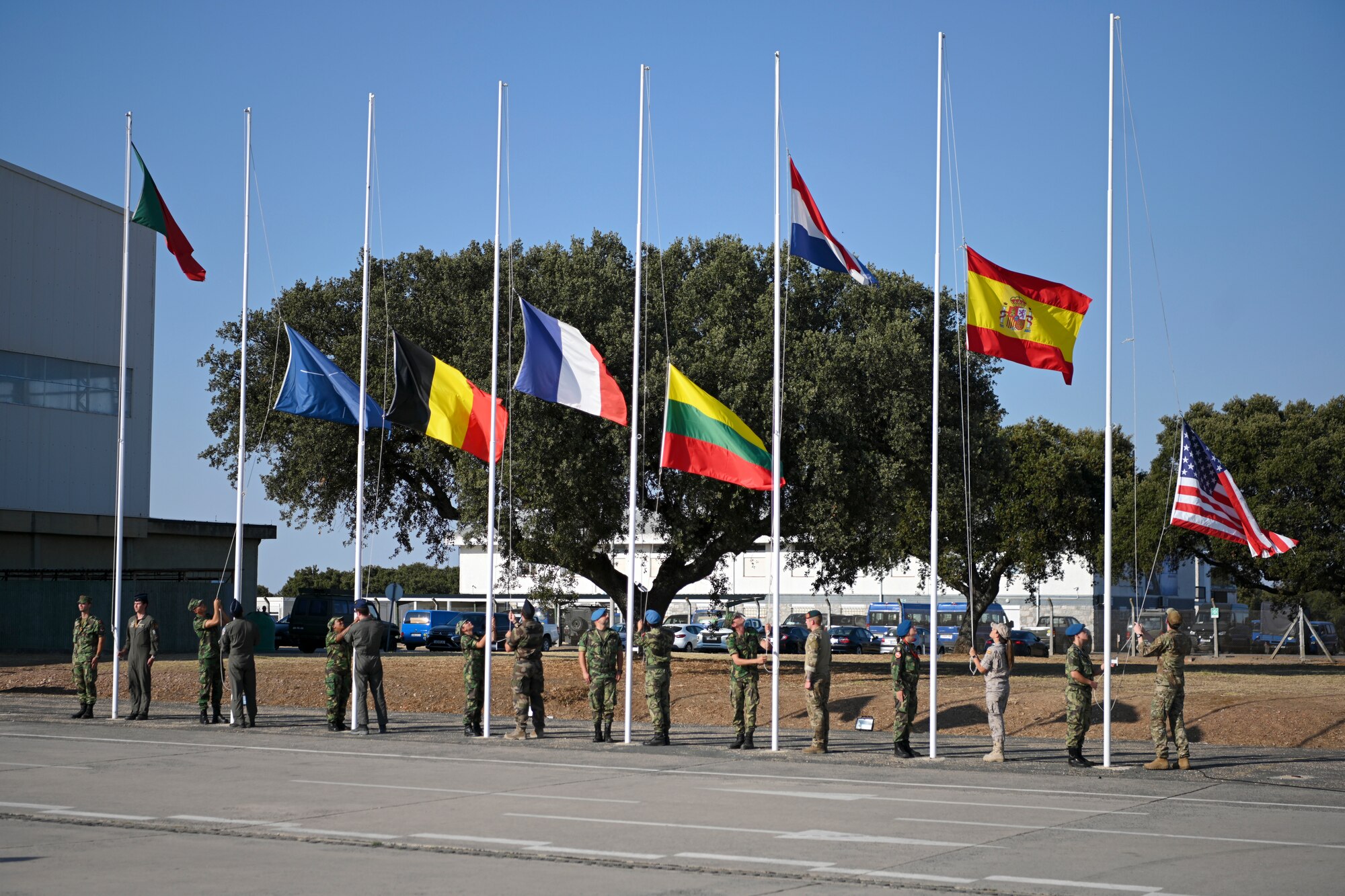service members lowering flags
