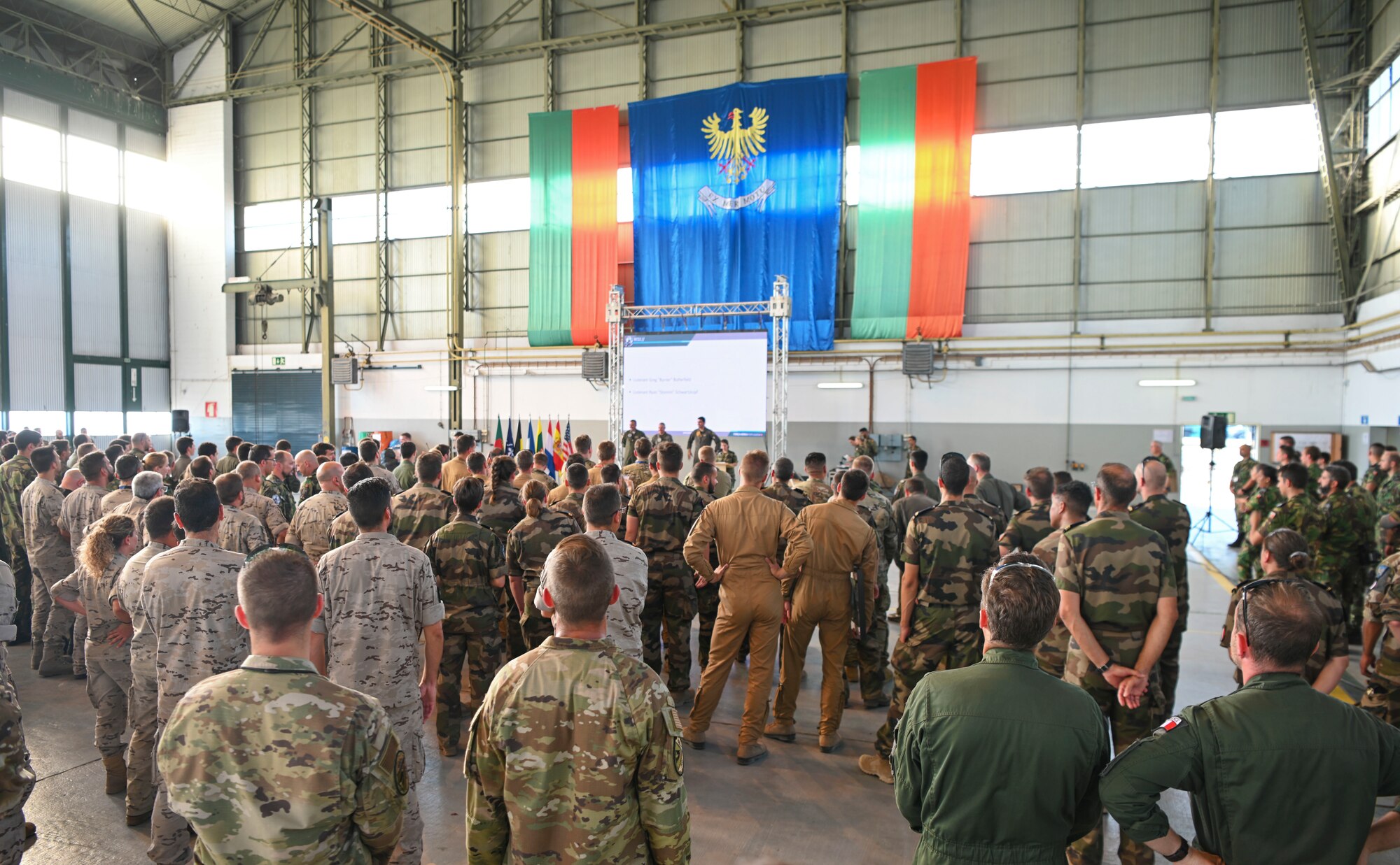 Service members gathering in a hangar