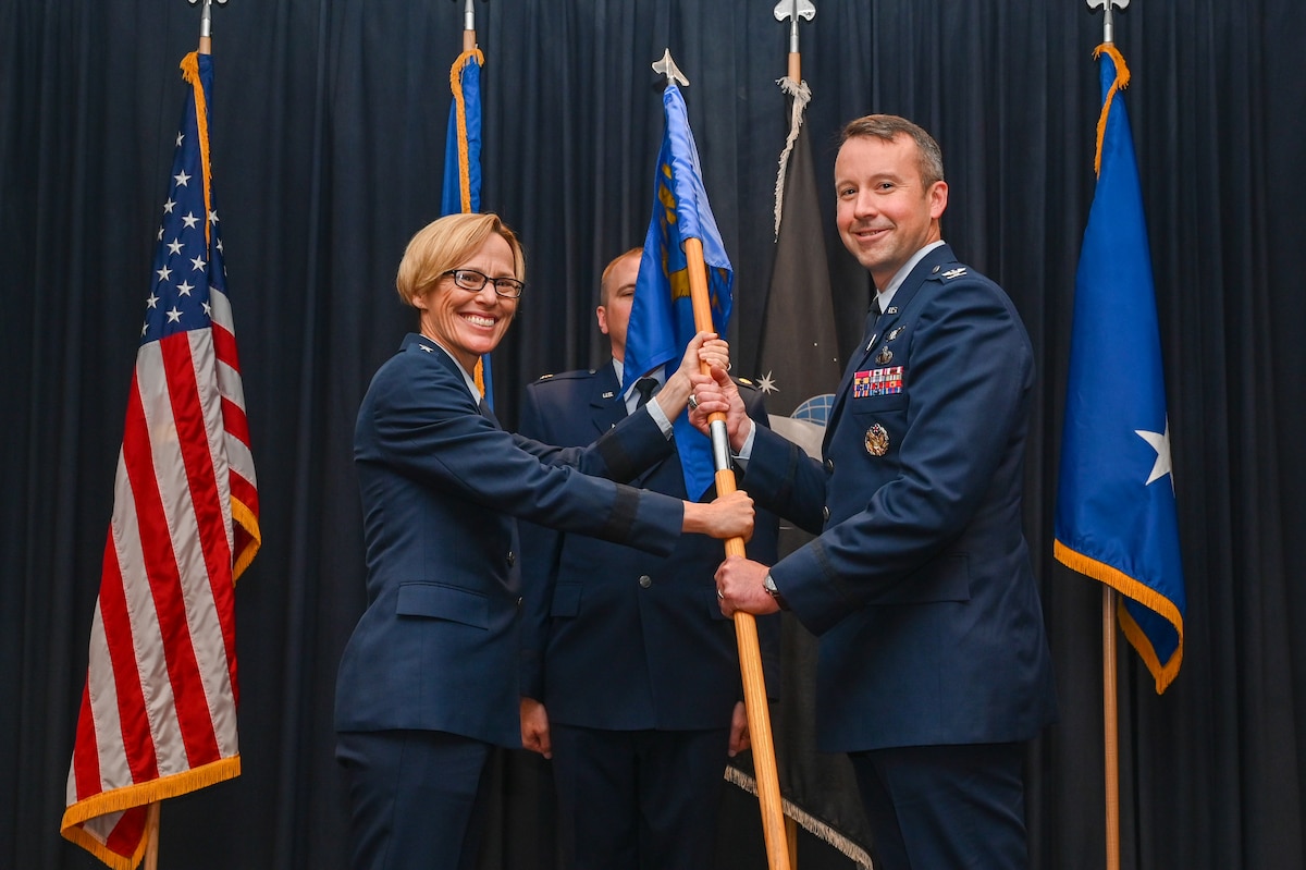 Col. Jeremy A. Raley assumes command of the Air Force Research Laboratory Phillips Research Site as AFRL commander Maj. Gen. Heather Pringle passes him the unit guidon at a change of command ceremony July 13, 2022 at Kirtland Air Force Base, New Mexico. Raley became the AFRL Space Vehicles Directorate director as well as the site commander, which includes the AFRL Directed Energy Directorate. (U.S. Air Force photo/Staff Sgt. Miranda Loera)
