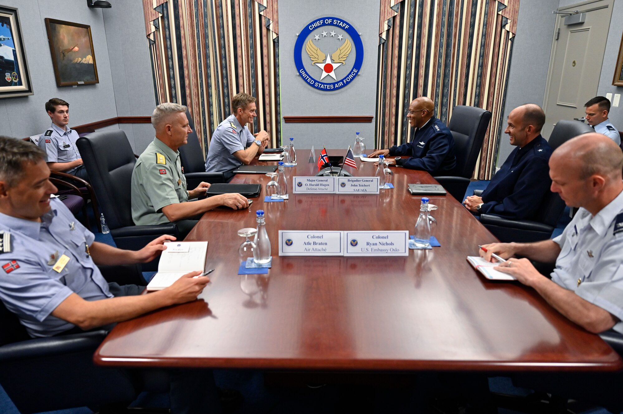 Air Force Chief of Staff Gen. CQ Brown, Jr., center right, speaks with Maj. Gen. Rolf Folland, chief of the Royal Norwegian Air Force.
