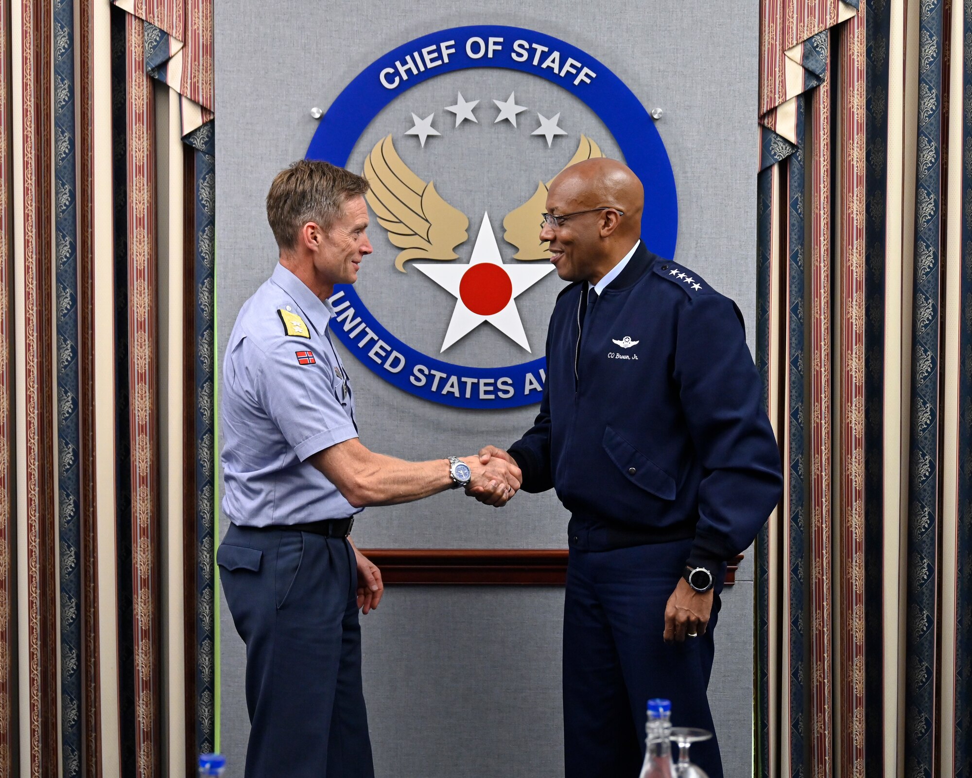 Air Force Chief of Staff Gen. CQ Brown, Jr. shakes hands with Maj. Gen. Rolf Folland, chief of the Royal Norwegian Air Force.