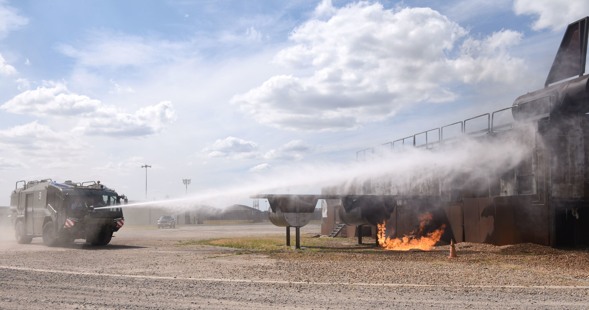 Colin Smith, 100th Civil Engineer Squadron Fire Department crew manager, demonstrates the P-19 Panther crash truck capabilities to Henry Griffin, Suffolk Fire and Rescue area manager, 100th CES honorary commander, during a visit to Royal Air Force Mildenhall, England, July 13, 2022. Griffin spent time with the fire department to ascertain what assets could be used for future mutual aid requests, as well as building relationships to carry out joint training between on- and off-base fire departments in the future. (U.S. Air Force photo by Karen Abeyasekere)