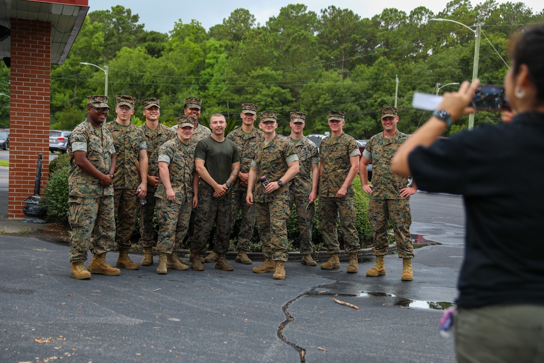 U.S. Marines with Headquarters and Headquarters Squadron (H&HS) stand together during the Freedom Family Fair at Marine Corps Air Station Beaufort, July 1, 2022. H&HS provided food, games and information about community resources to the squadron ahead of the Independence Day weekend. (U.S. Marine Corps photo by Sgt. Cheyeanne Campbell)