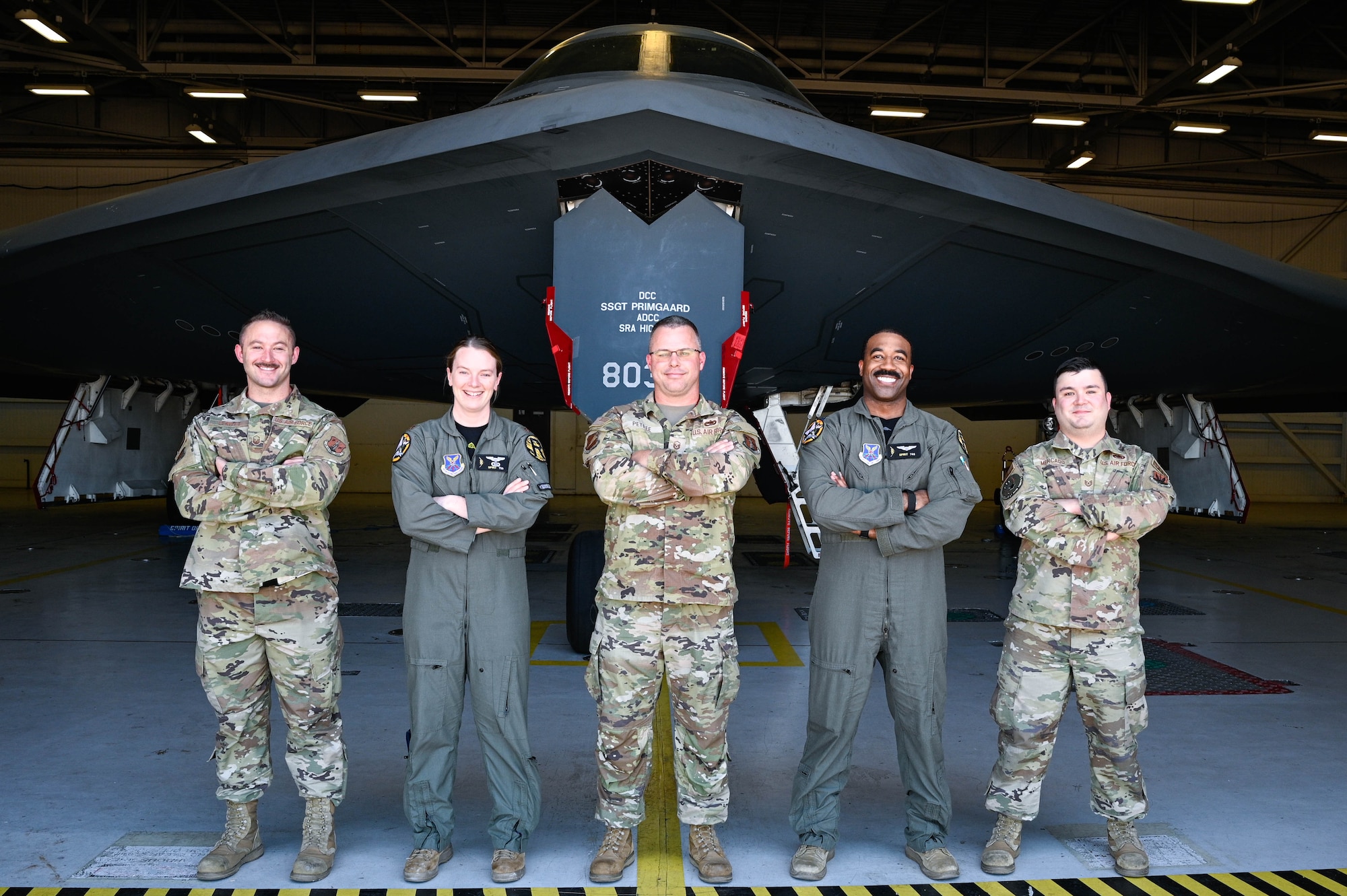 Airmen assigned to Whiteman Air Force Base stand for a photo to represent those who have received Spirit numbers at Whiteman AFB, Missouri, June 30, 2022. A Spirit number is a sequential number that is assigned only to a person who has flown in the B-2 Spirit Stealth Bomber which not only includes pilots but cabinet-level secretaries, senior military leaders, members of Congress and award winning enlisted military members. (U.S Air Force Photo by Senior Airman Christina Carter)