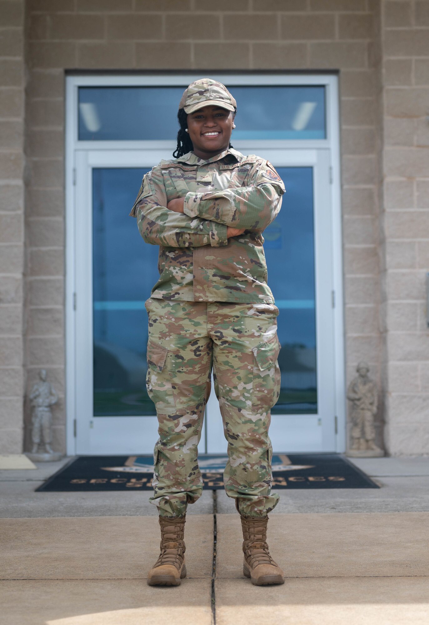 An Airman stands in front of a building for a photo.