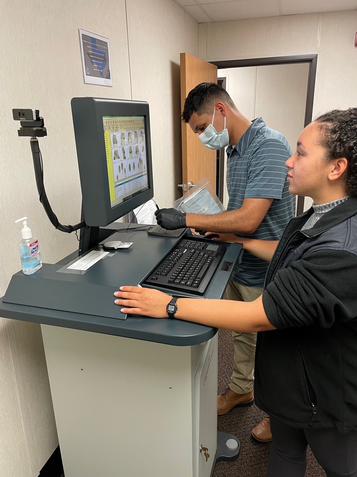 U.S. Air Force Special Agents Angela Velazquez-Colon, right, and Steven Hinojosa-Rodriguez, left, Department of the Air Force Office of Special Investigations Detachment 223, are utilizing the Livescan Management Software to capture and process fingerprints at Tyndall Air Force Base, Florida, June 22, 2022.